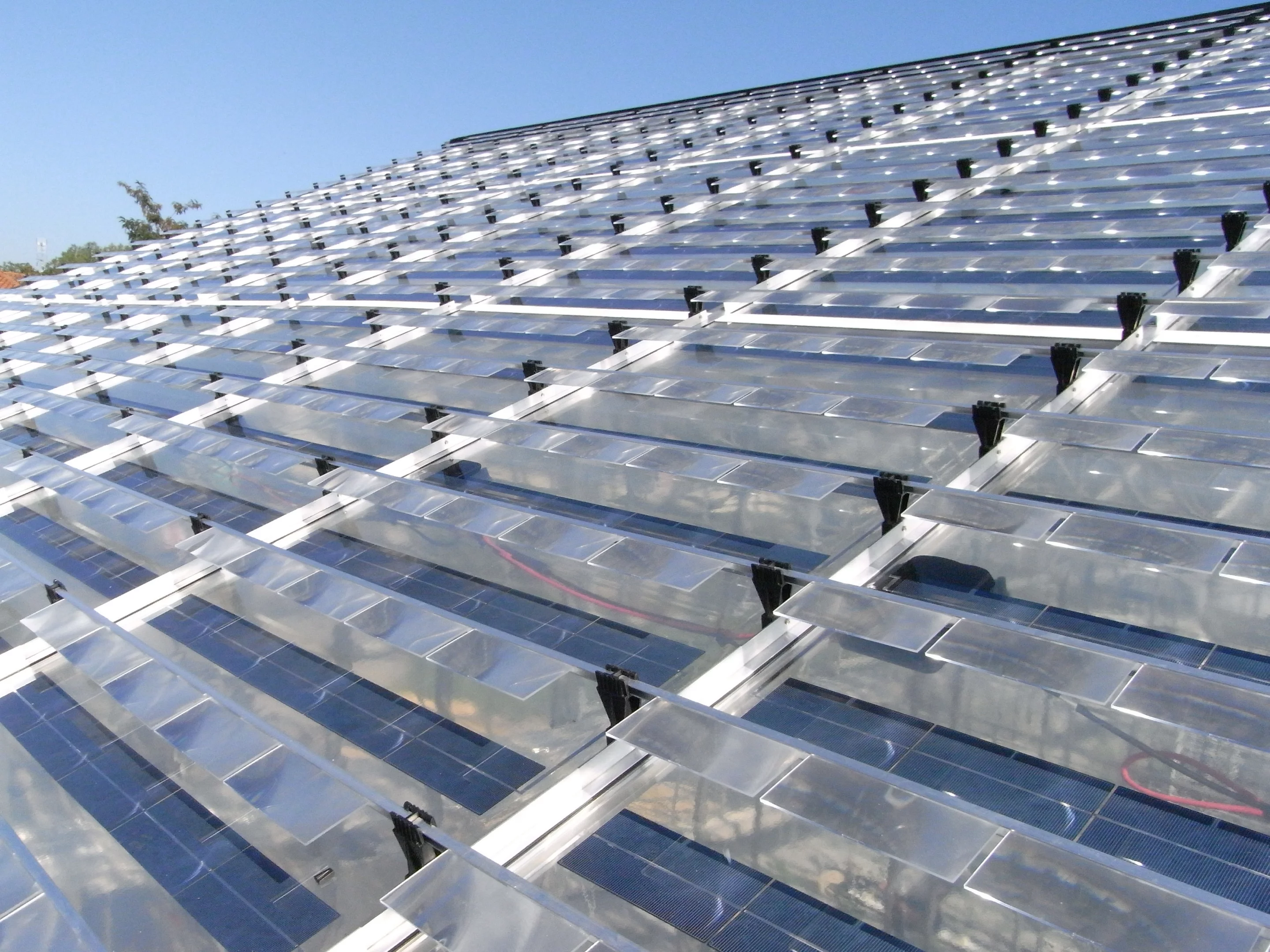 A close-up of the greenhouse roof reveals the elevated positioning of the lenses