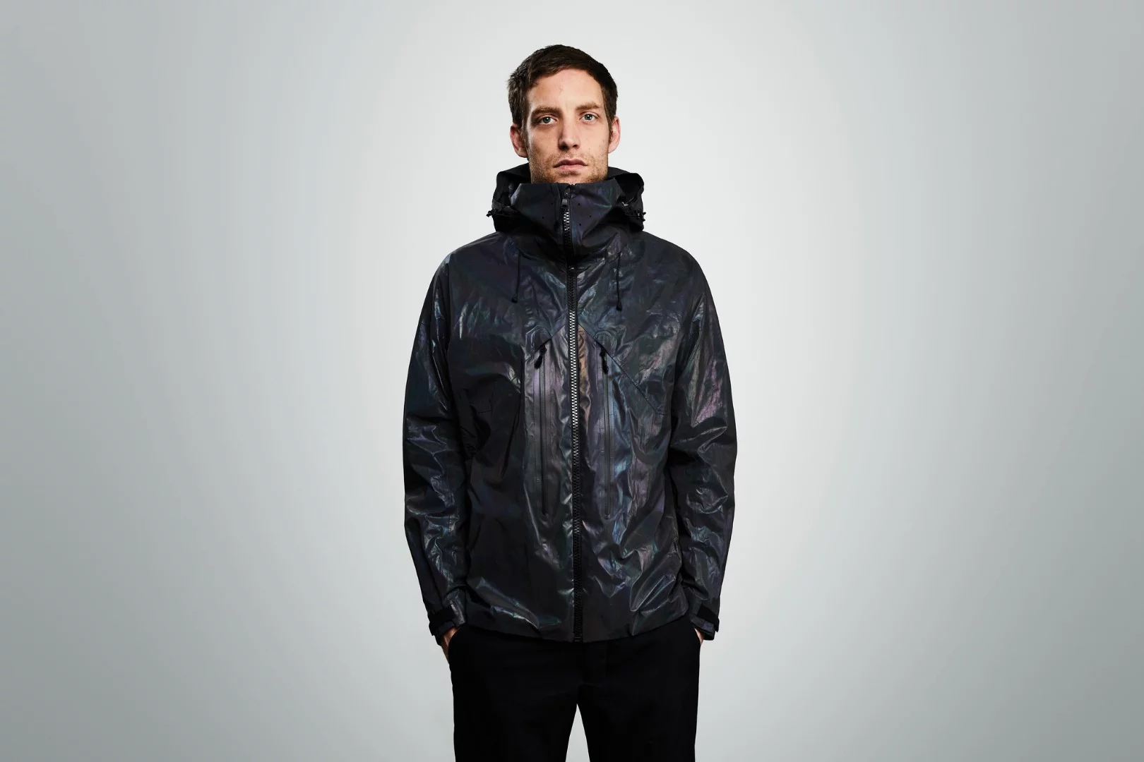 The Black Squid Jacket has a black, "oily" appearance in indoor or subdued outdoor lighting conditions