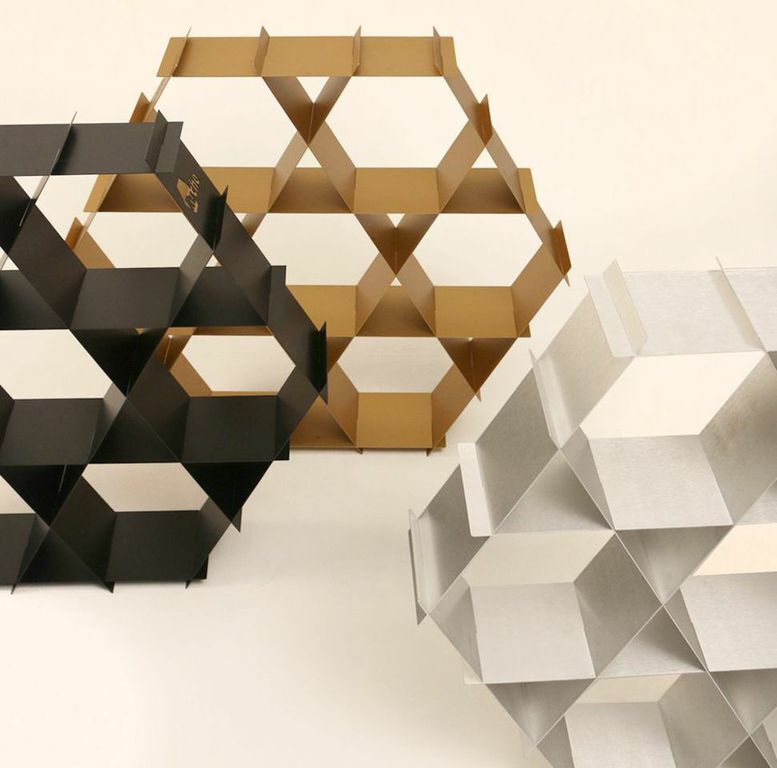 Shipped as a pile of aluminum or cardboard sheets, the pieces slot into one another to form an array of hexagonal and triangular shelves