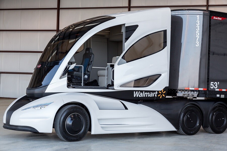 The aerodynamic cab of the tractor unit features a sliding door, a center-mounted driver's seat, an all-LCD dash that can be customized to suit the driver's preferences, and a full-sized sleeper
