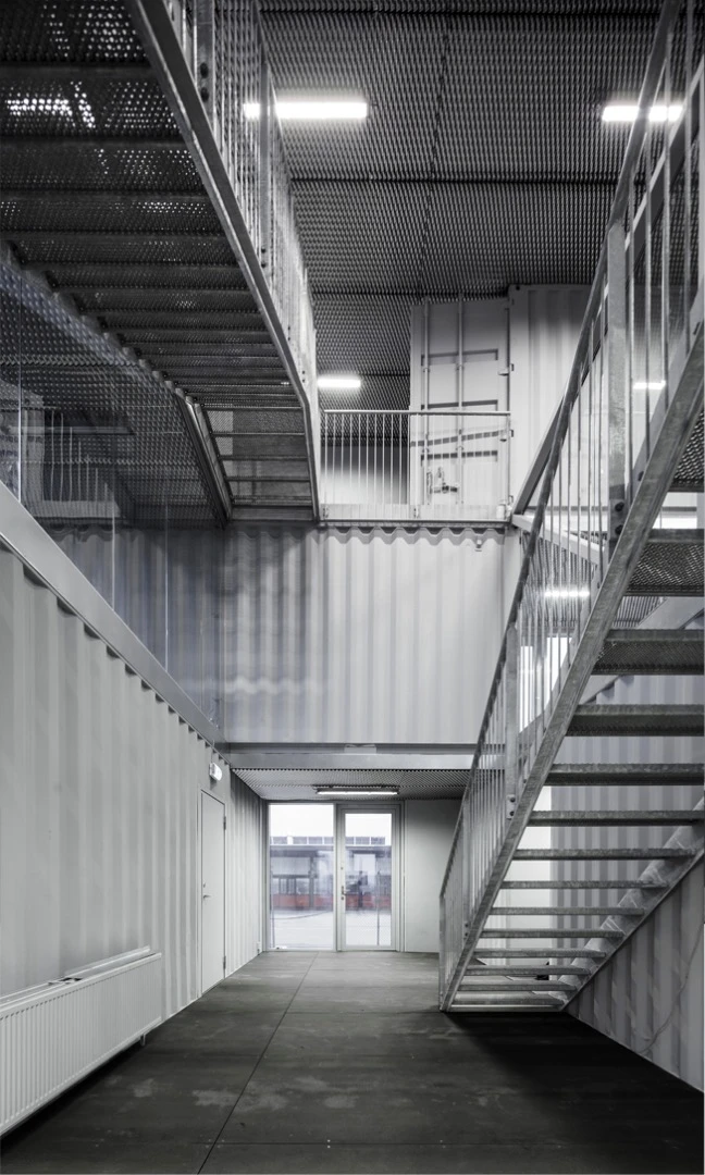 Made to be Moved features used shipping containers – complete with dents – that have been painted grey to produce a uniform look