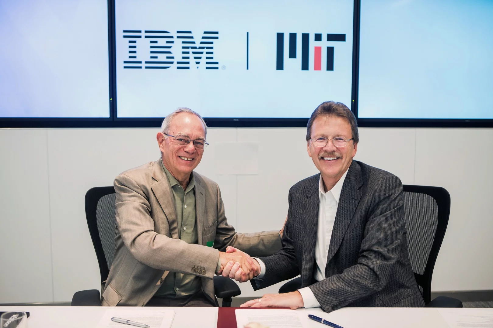 MIT President L. Rafael Reif, left, and John Kelly III, IBM senior vice president celebrate the new collaboration