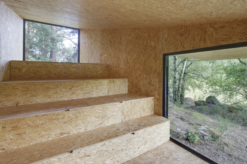 Uhlik Architekti inserted four large steps which serve as both seating areas and storage (Photo: Jan Kudej)