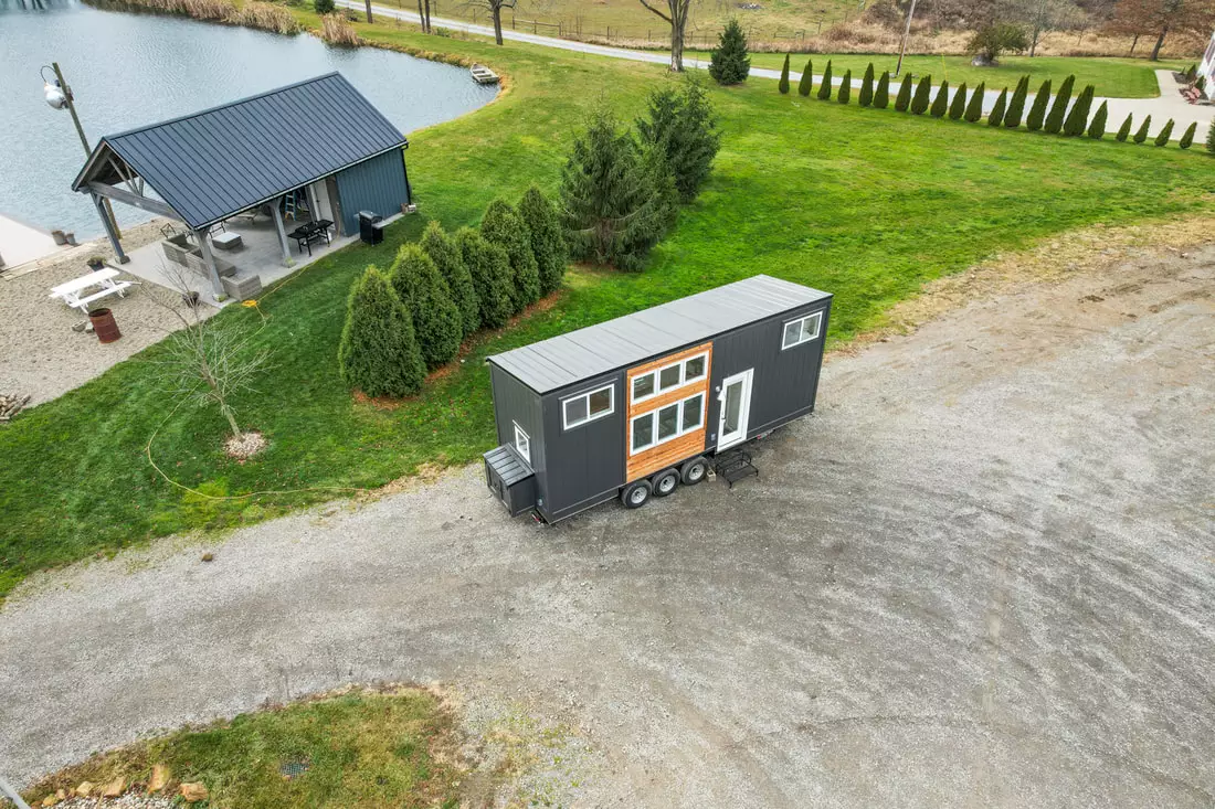 The Ulla-Carin is finished in vertical smart siding, with cedar accenting and a metal roof