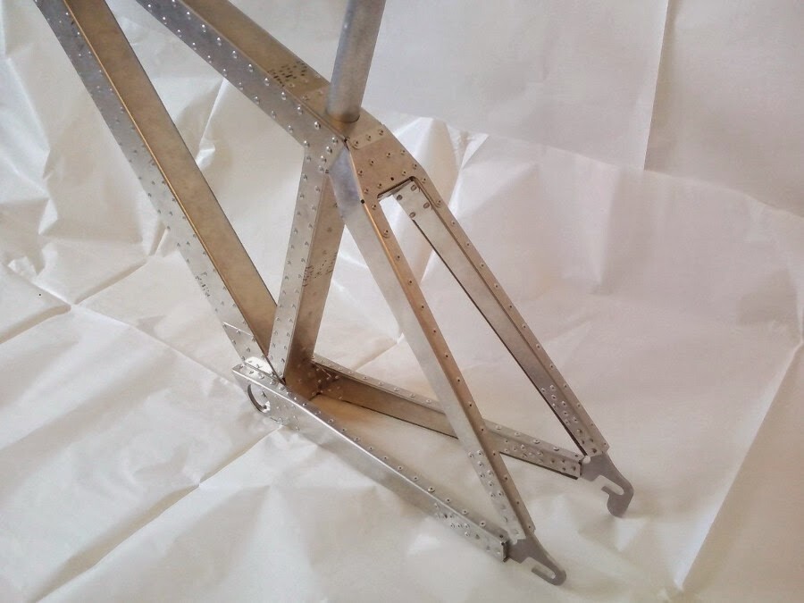 Using a CNC (computer numerical control) system, the main components of the frame are first cut from sheets of aluminum