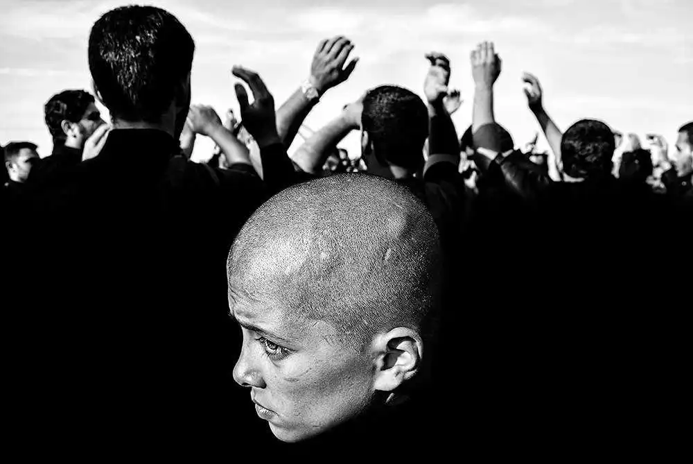 Finalist in The Photojournalist category of the 2018 EyeEm Awards: A boy watches protest groups in Mashhad, iran