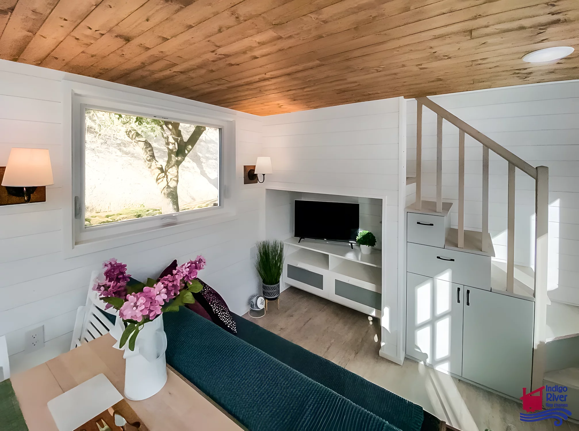 The Elsie's living room includes a sofa bed for guests and an entertainment center with a TV