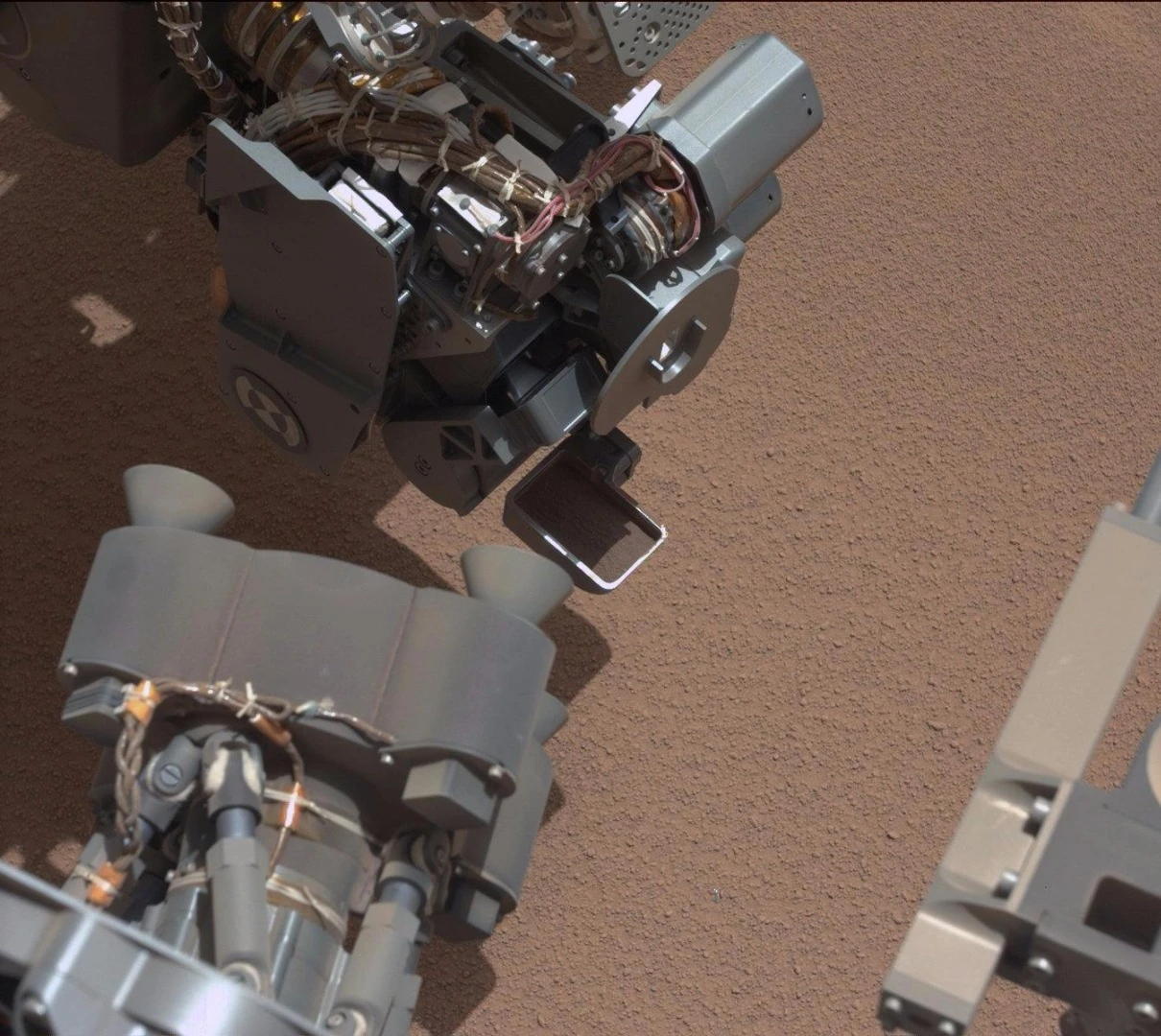 Curiosity collecting soil samples