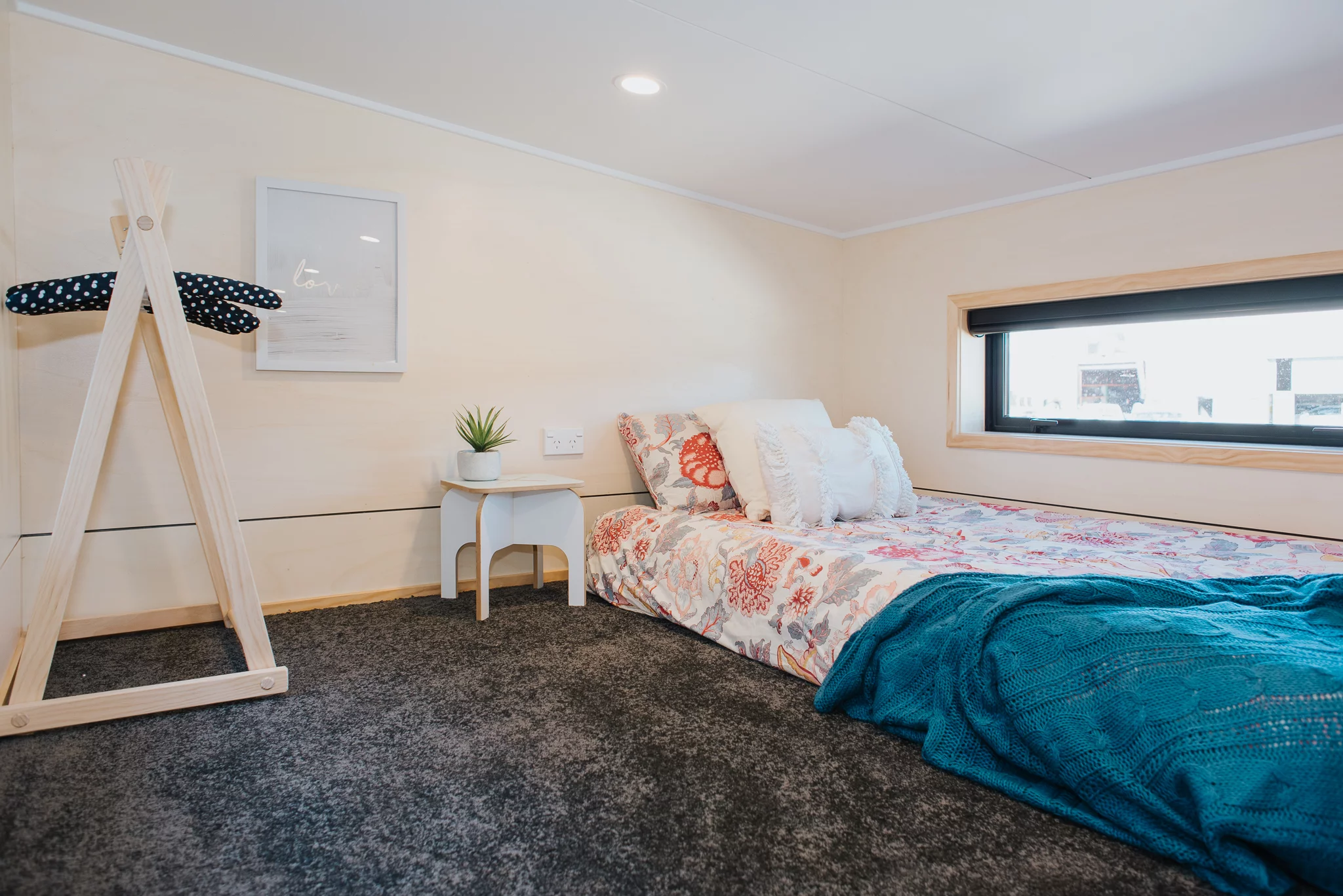 The Dreamweaver Tiny House's second bedroom serves as the kid's room and includes a single bed