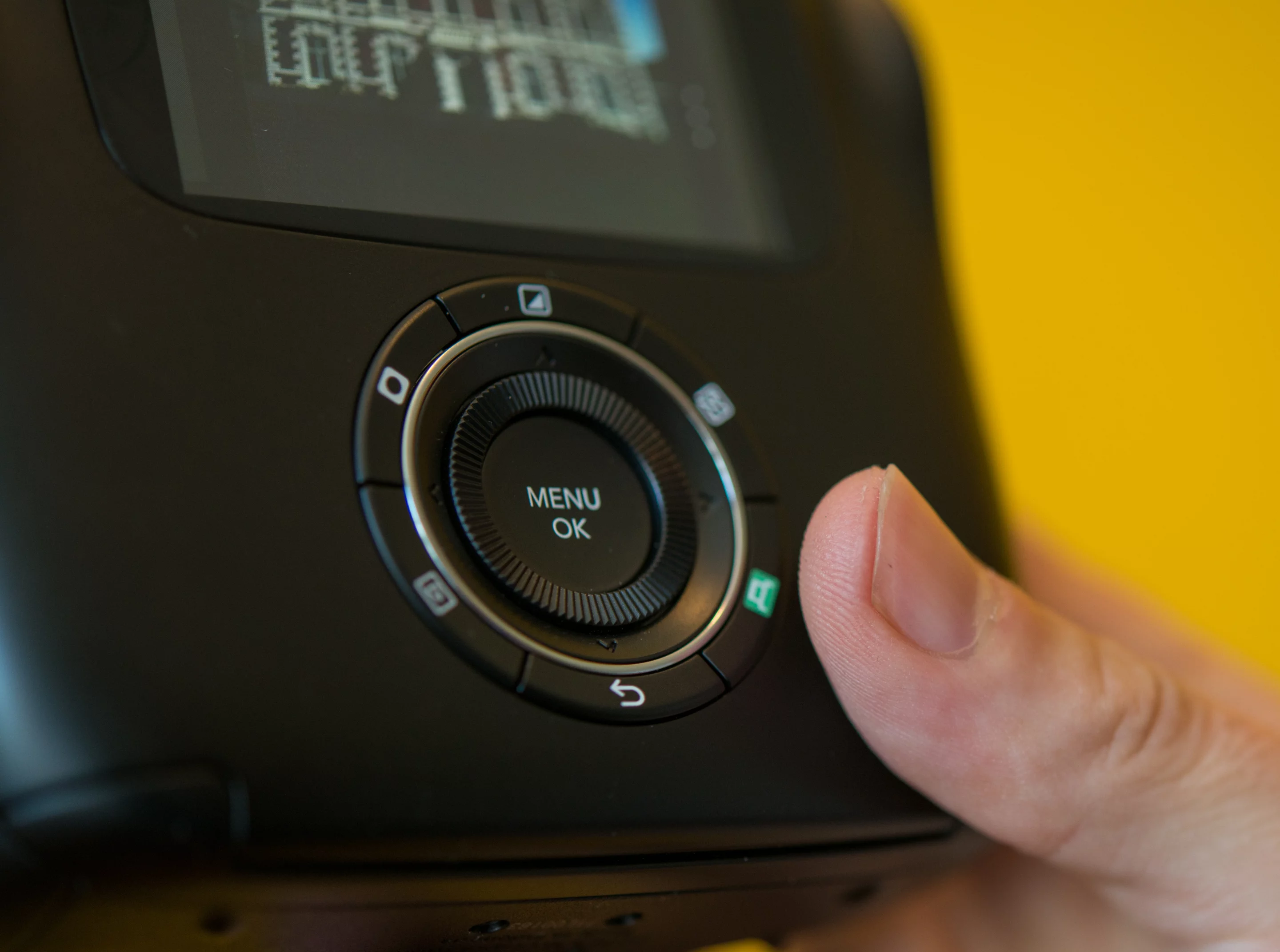 The print button on the Fujifilm Instax SQ10 digital instant camera