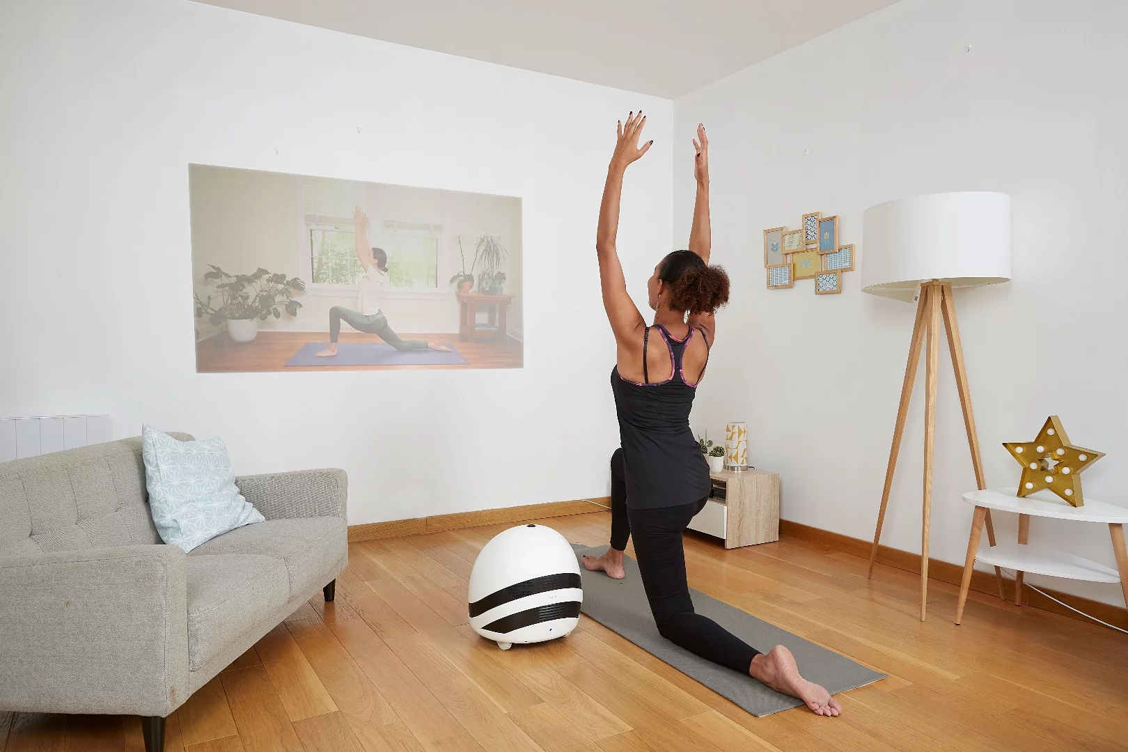 Keecker helping with yoga exercises in the living room