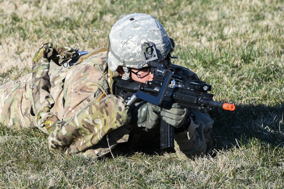 Army Sgt. Michael Zamora assumes a prone fighting position using a prototype Third Arm exoskeleton device