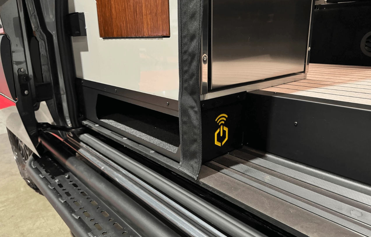 We thought it weird that Remote Vans integrated internet hardware into the door sill, but that yellow graphic is just the company's logo on the front of a handy shoe box that serves for stowing dirty or wet footwear before entry