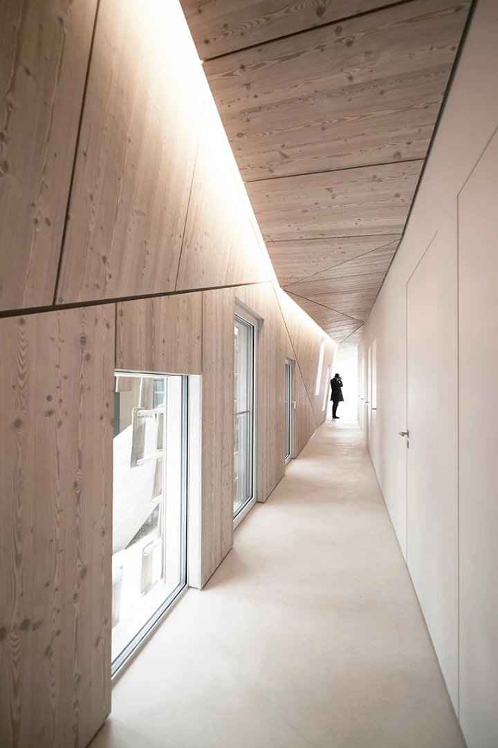 The interior of the home features a series of rooms which run off a long corridor