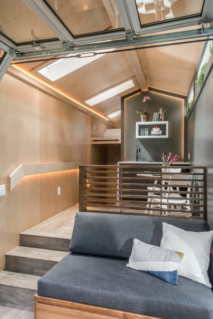 The Orchid Tiny House's sofa pulls out into a bed