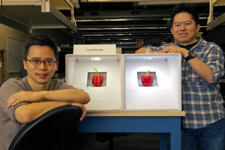 LumiSands founders Chang-Ching Tu (left) and Ji Hoo, demonstrating the warmer hue of an LED bulb utilizing their technology