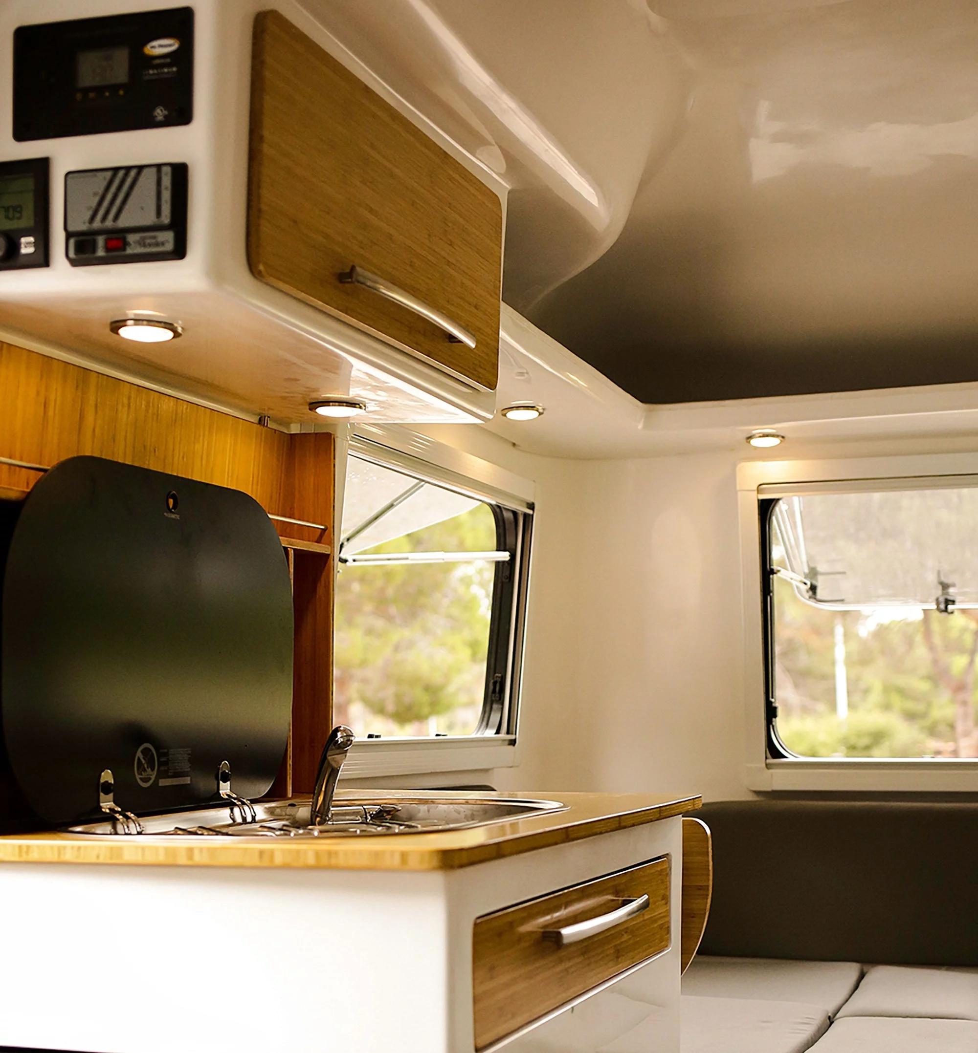 The big additions in the Traveler are the bathroom and the kitchen block with dual-burner stove, sink and fridge drawer