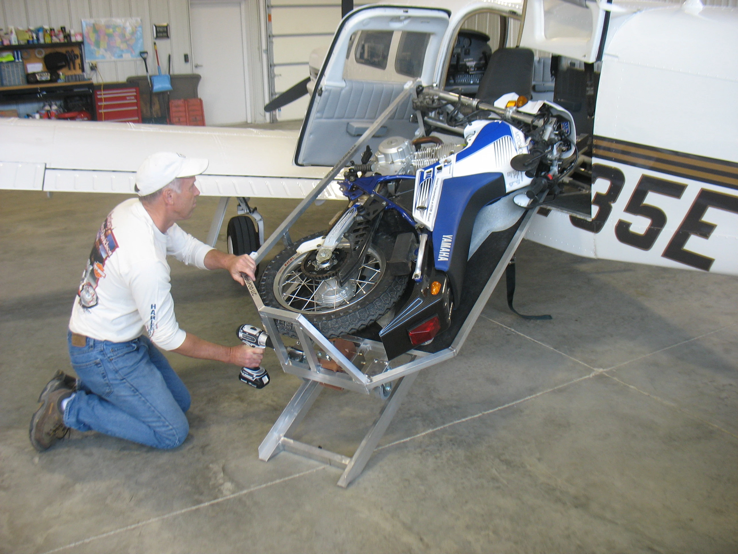 The MotoLOAD winches a MotoCYCLE into an airplane using a cordless drill