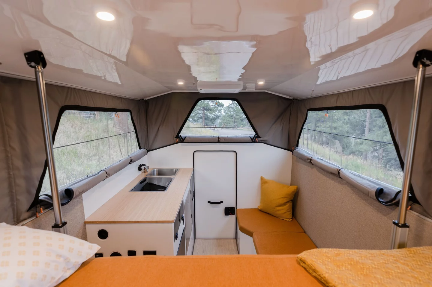 The bench seat next to the entry door is where campers will find the available toilet and pop-out shower