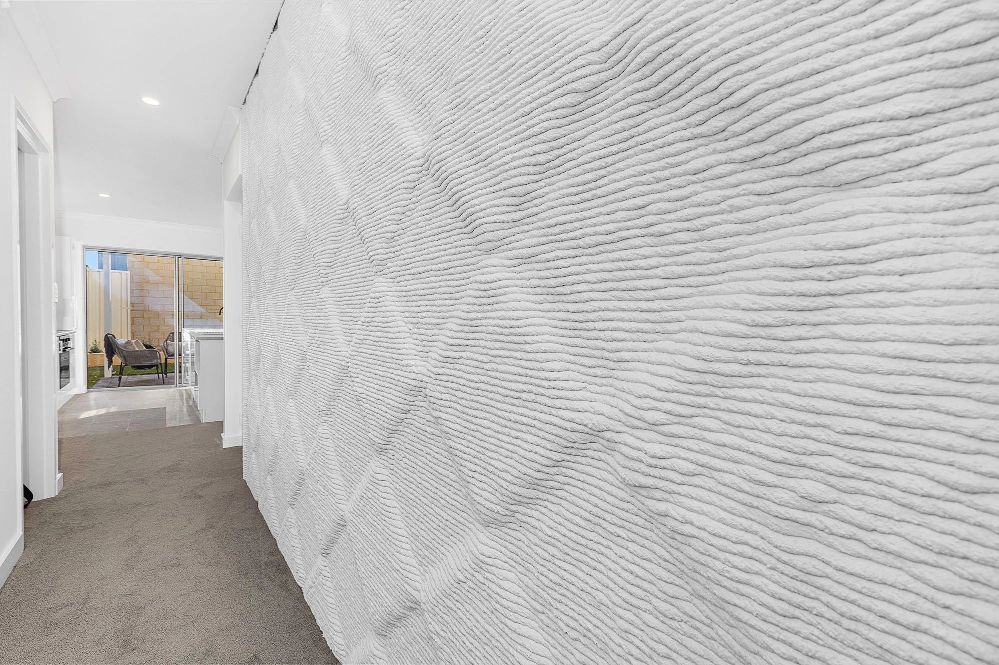 The 3D-printed house's interior decor is a mixture of smooth walls and ribbed 3D-printed wall sections