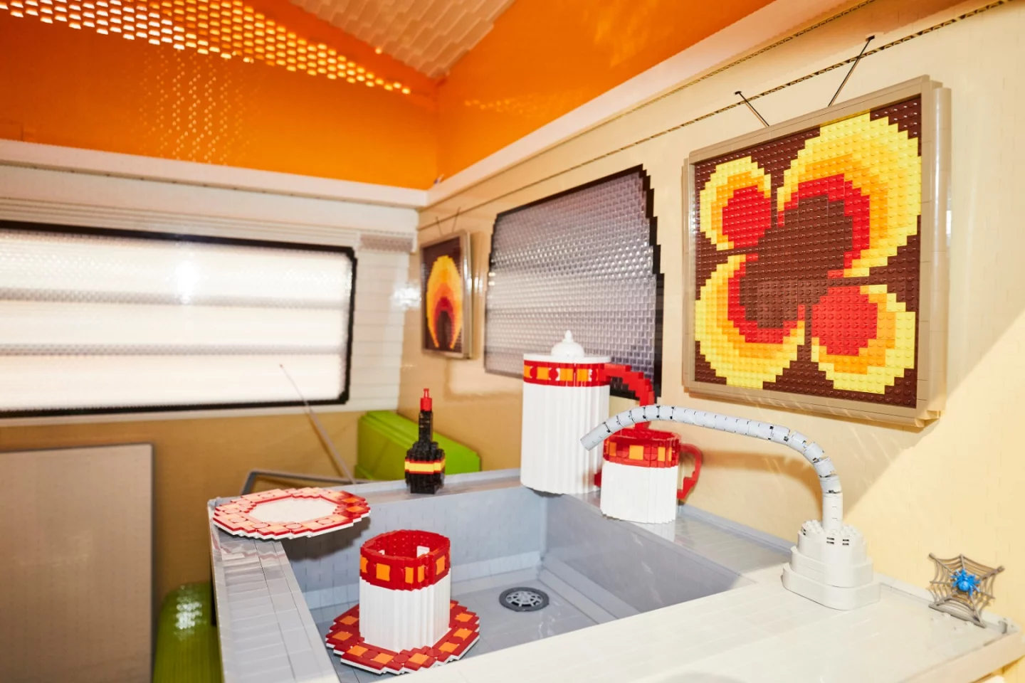There's no mention of running water or working amenities, but the Lego VW T2a does include a fully detailed interior with kitchen and dining lounge