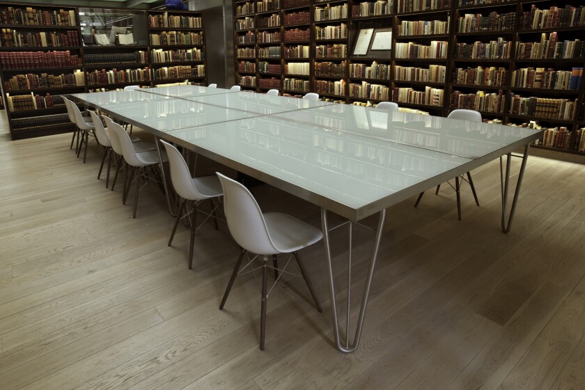 Pale floors and furniture contrast with the shelves