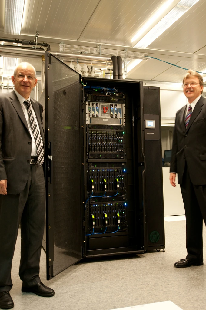 Prof. Ralph Eichler, President, ETH Zurich and Dr. John Kelly, Senior Vice President IBM Research, stand besides Aquasar, a first-of-a-kind, warm-water cooled supercomputer unveiled to the public for the first time