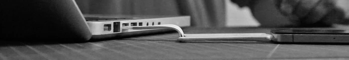 The ChargeCard plugs into a laptop and cell phone