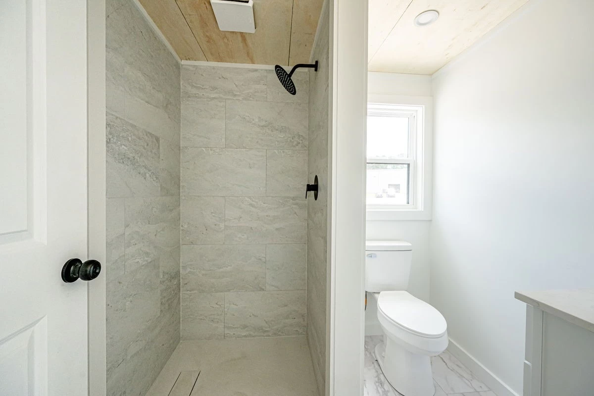 The Rowan's bathroom features a sink, shower, and flushing toilet