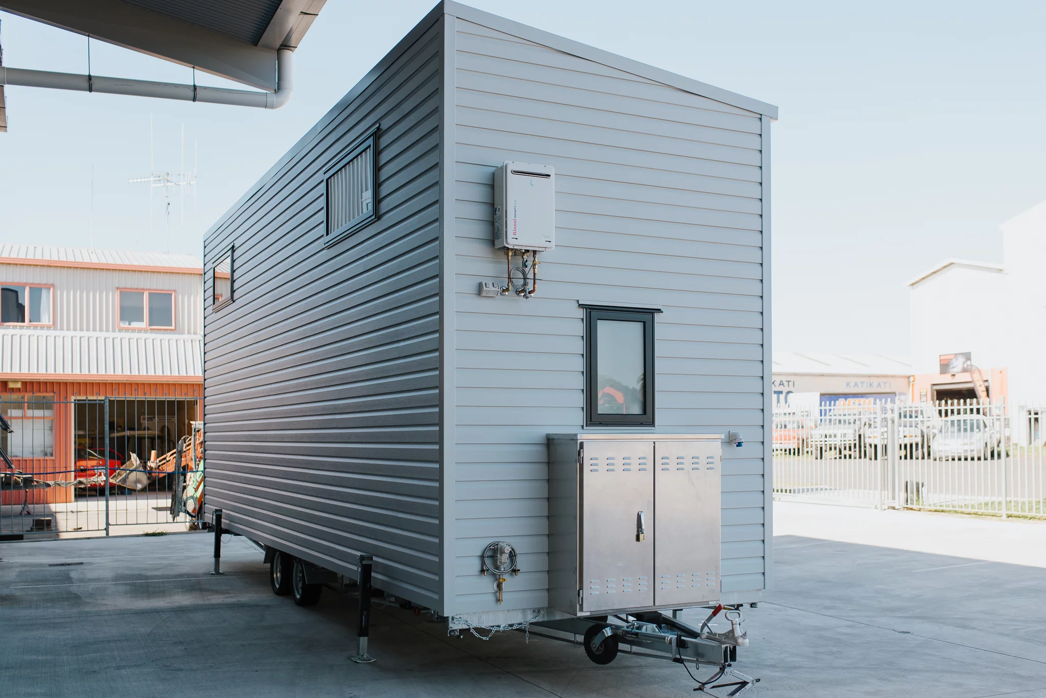 The Dreamweaver Tiny House has a storage box on its exterior that contains the inverter and batteries for the solar panel setup
