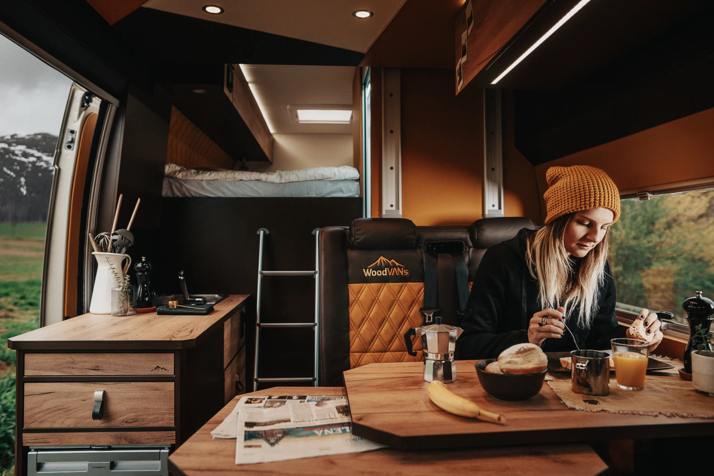 The WoodVans Moto includes an "upstairs" bedroom over top the rear garage, a passenger-side kitchen and a driver-side wet bathroom