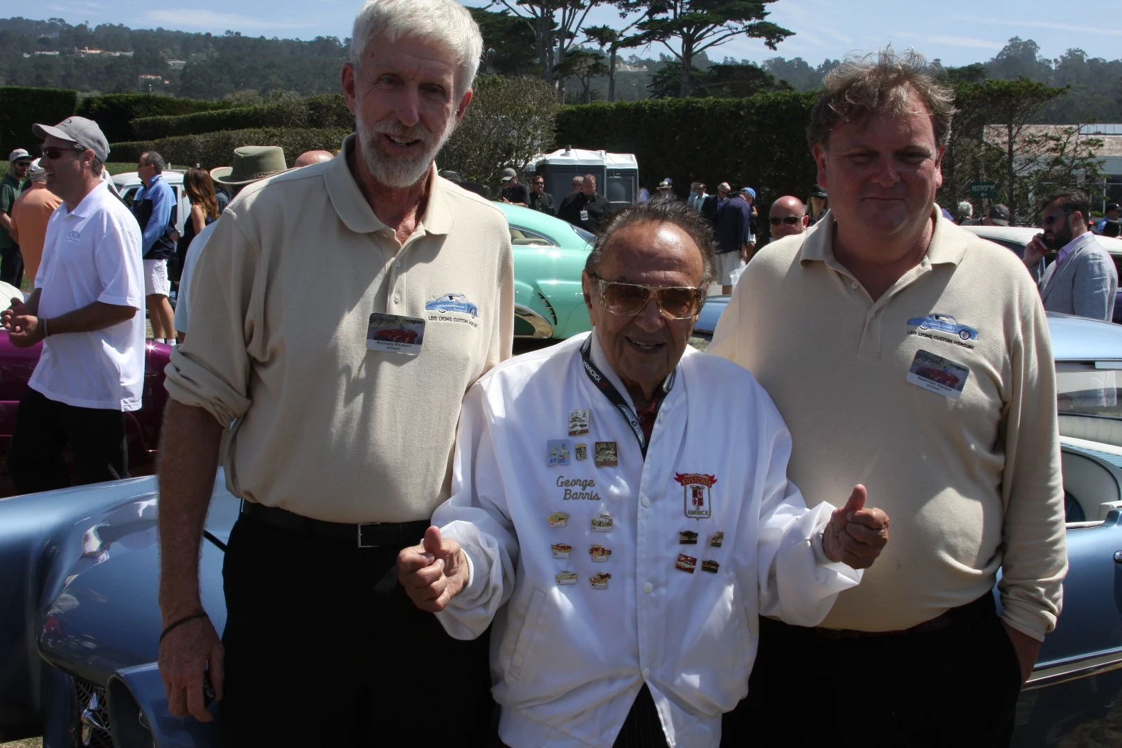 George Barris poses with the owners of the Leo Lyon's Mercury custom at Pebble Beach