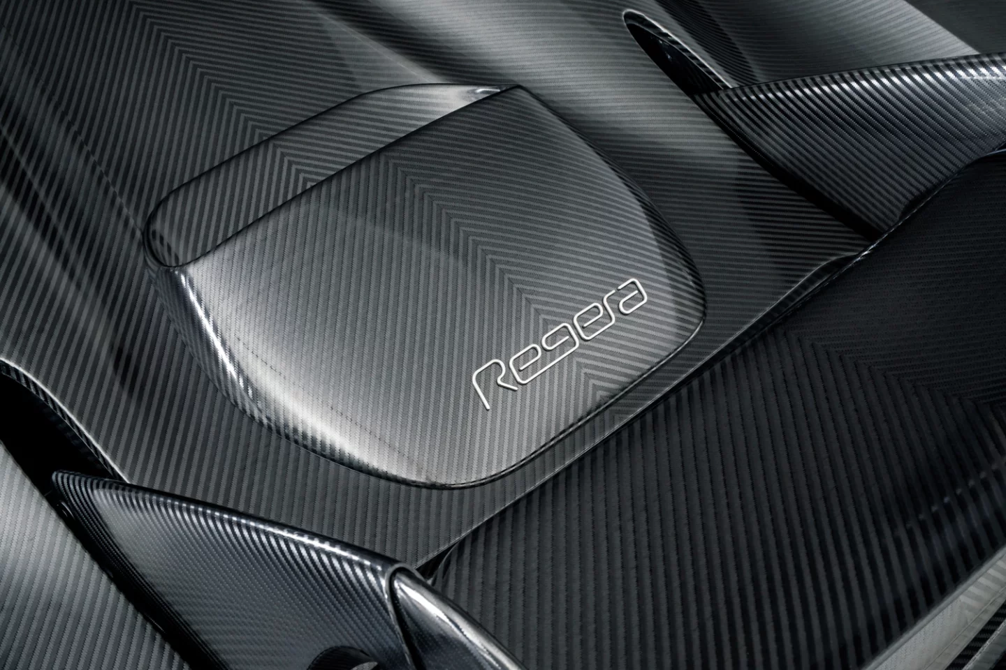 Koenigsegg's KNC Regera: the naked carbon has a graphite-like sheen as the light catches the strands