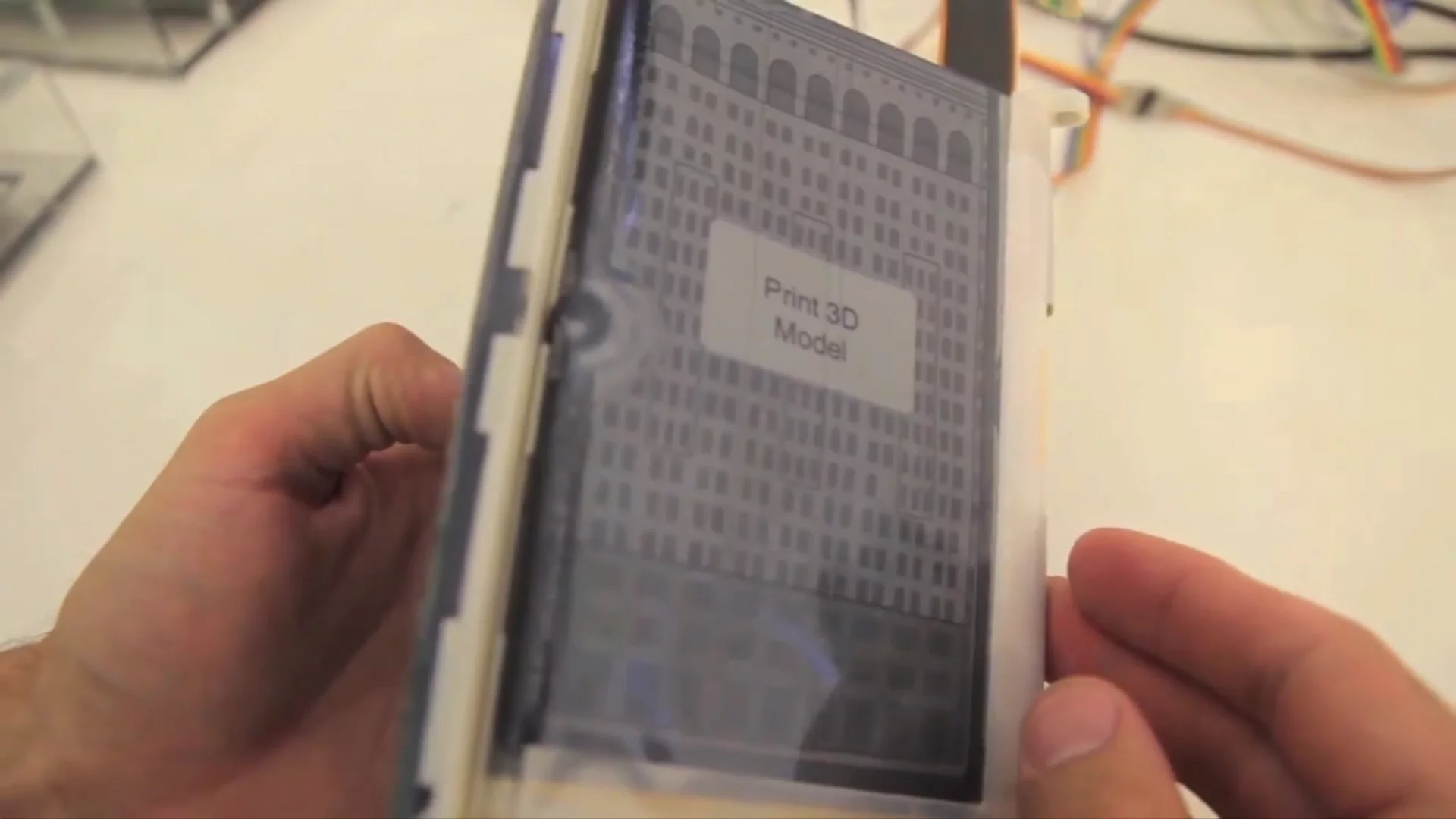 Folding the device so it resembles the shape of a building on the map switches the view to a 3D SketchUp model of the displayed building