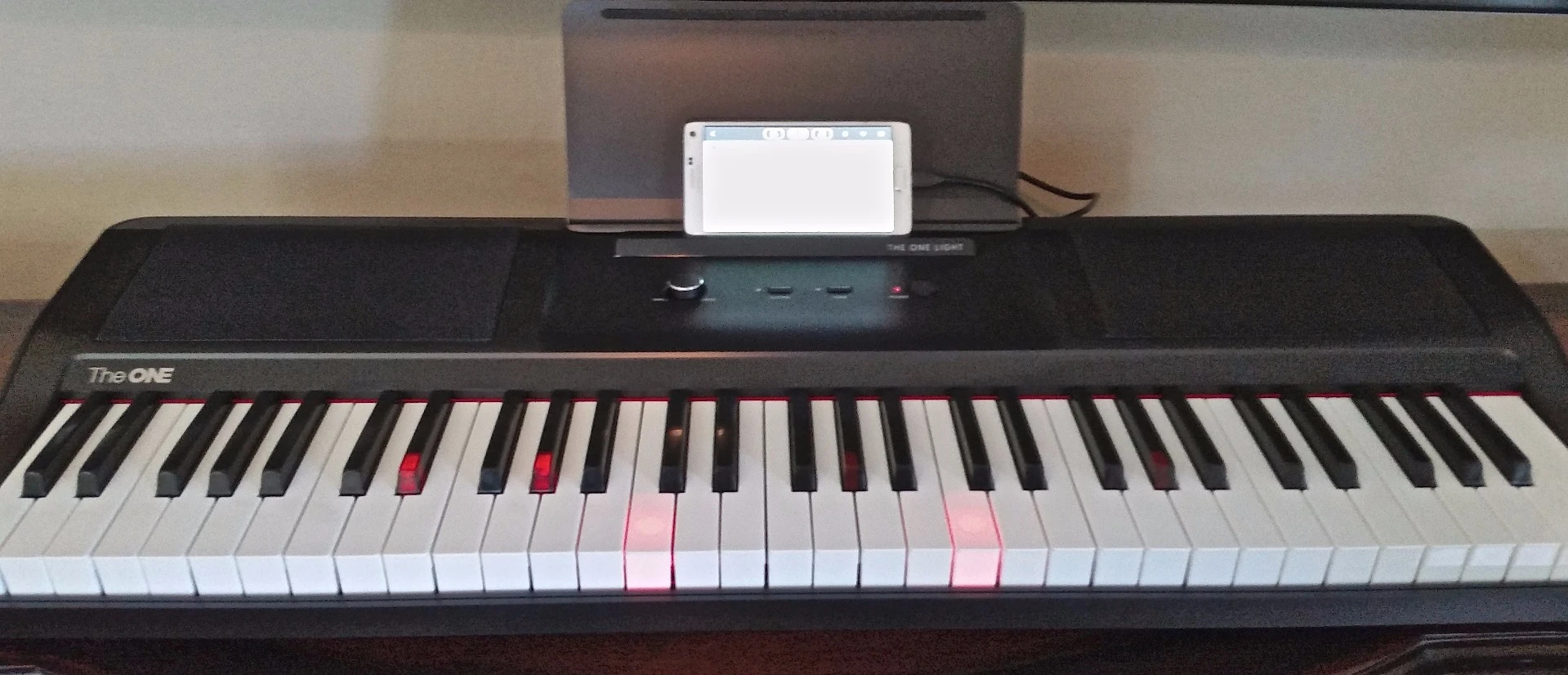 Lighted keys indicating the notes being played from sheet music