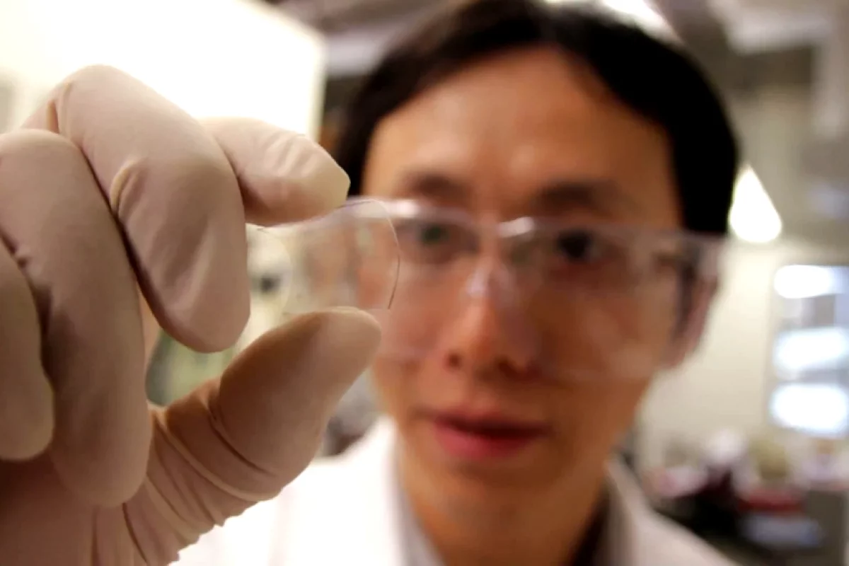 Postdoctoral researcher Yu Zhu with the graphene-based hybrid film on a flexible plastic substrate