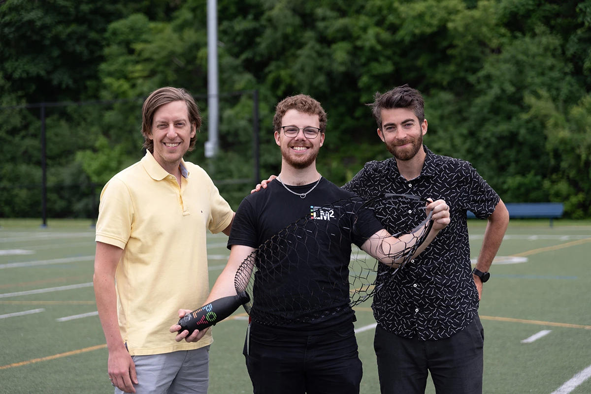 Researchers Frédérick Gosselin (left), Danick Lamoureux (middle), and David Mélançon (right) with a prototype of their kirigami-patterned plastic parachute