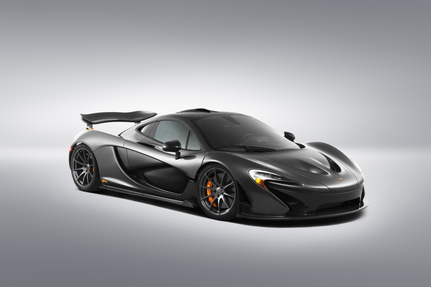 Orange brake calipers stand out from behind the P1's wheels