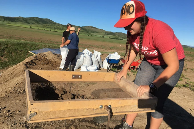 Archaeologists sift through the dirt at the dig site, looking for ceramic fragments
