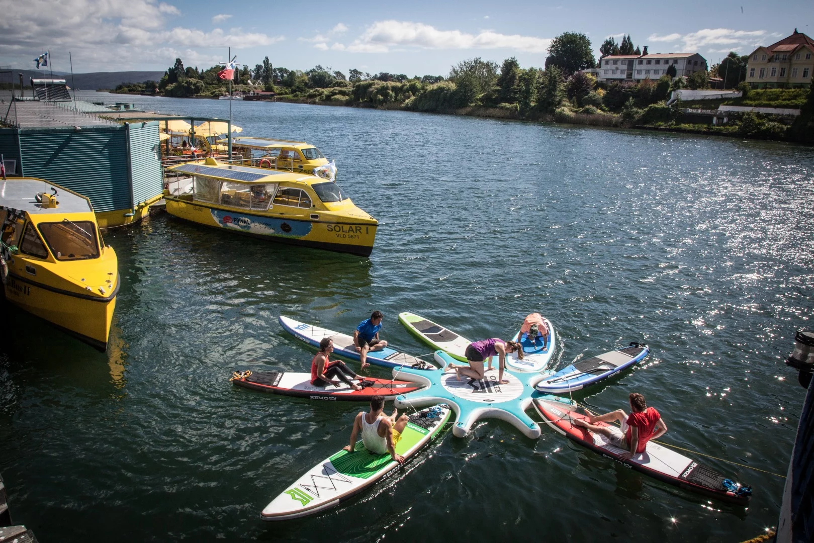 Stand-up paddlers warm up outside Barrio Flotante