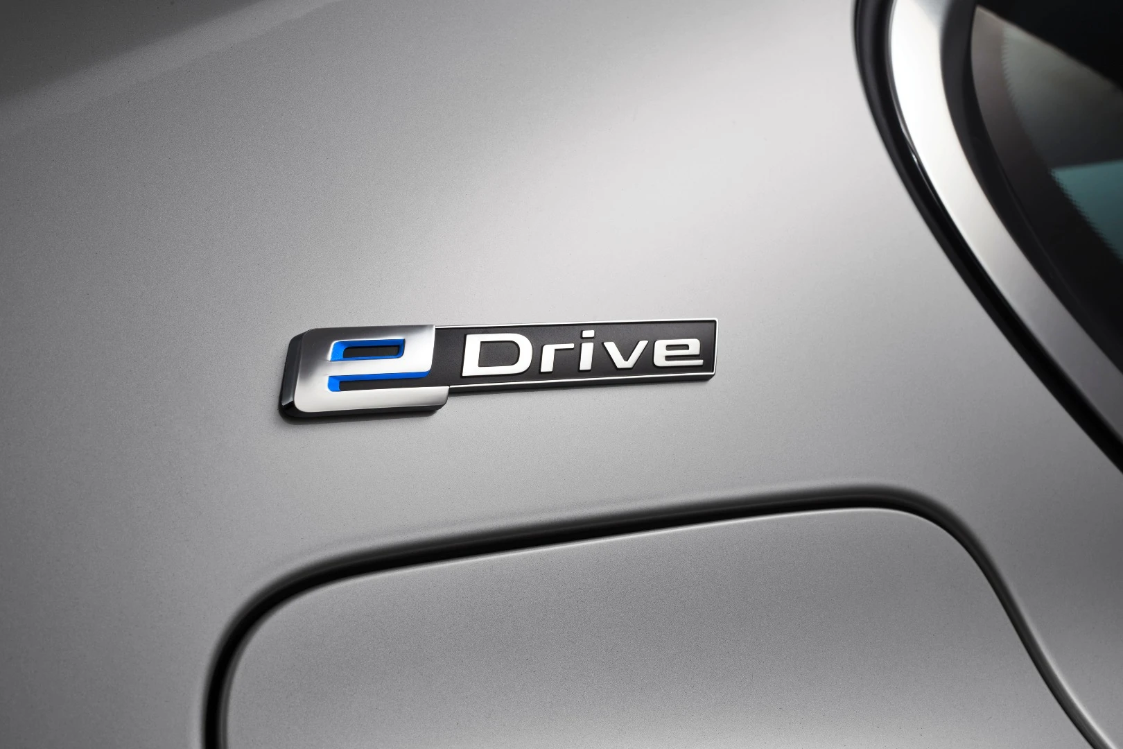 The eDrive logo on the rear pillar denotes the car's plug-in status