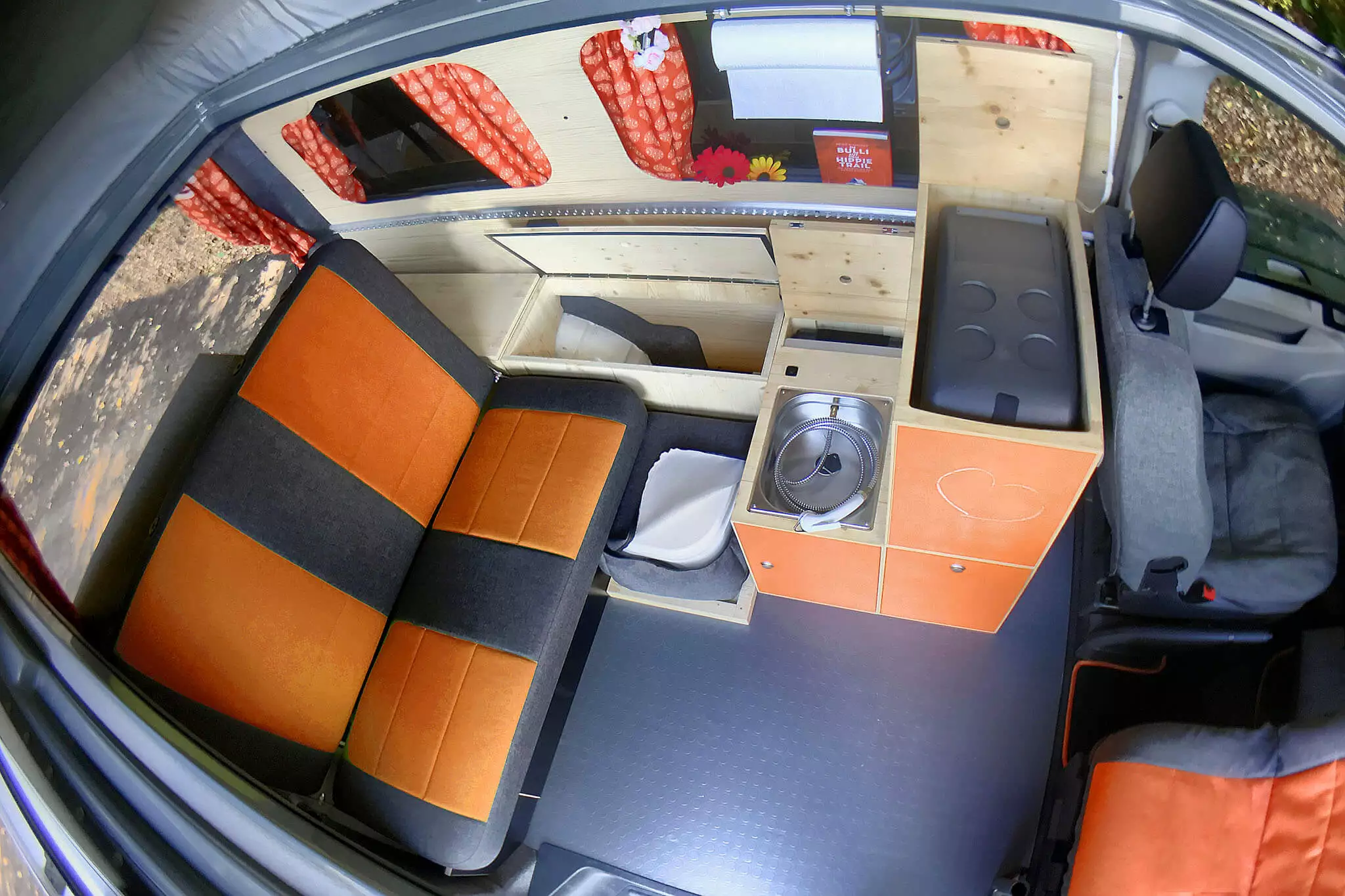 This Frieda model includes an optional two-seat bench with extra side storage; all models come with the box kitchen with fridge, sink, water and single-burner stove