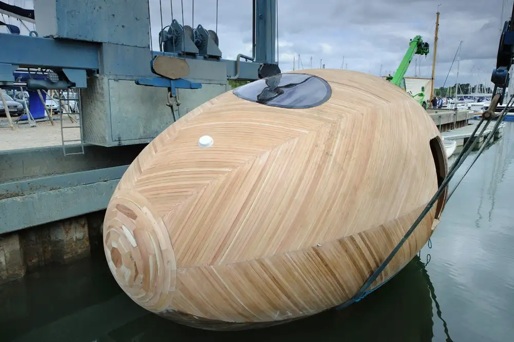 The Exbury Egg's construction was entrusted to local boat-builder Paul Baker, who used reclaimed cedar, and locally-sourced Douglas Fir to produce a buoyant, waterproof structure measuring roughly 6 x 2.8 m (20 x 10 ft)