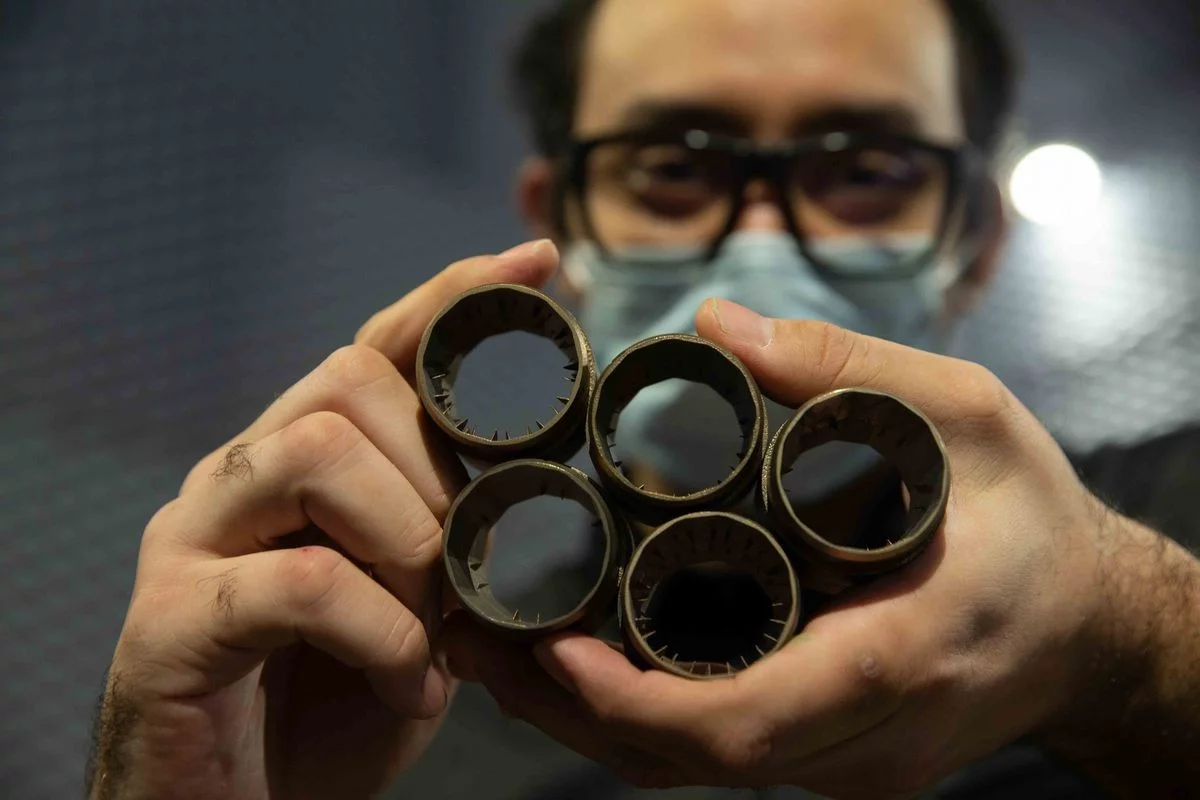 Doctoral student Mohammad Saleem with some of the test nozzles – they were designed in a collaboration between the University of Cincinnati, the US Naval Research Laboratory and Naval Air Station Patuxent River