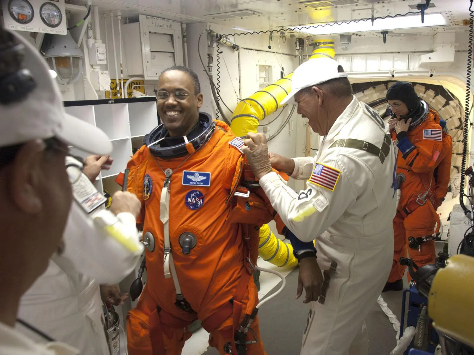 STS-133 Mission Specialist Alvin Drew puts on the parachute for his launch-and-entry suit pre-launch (Image: NASA)