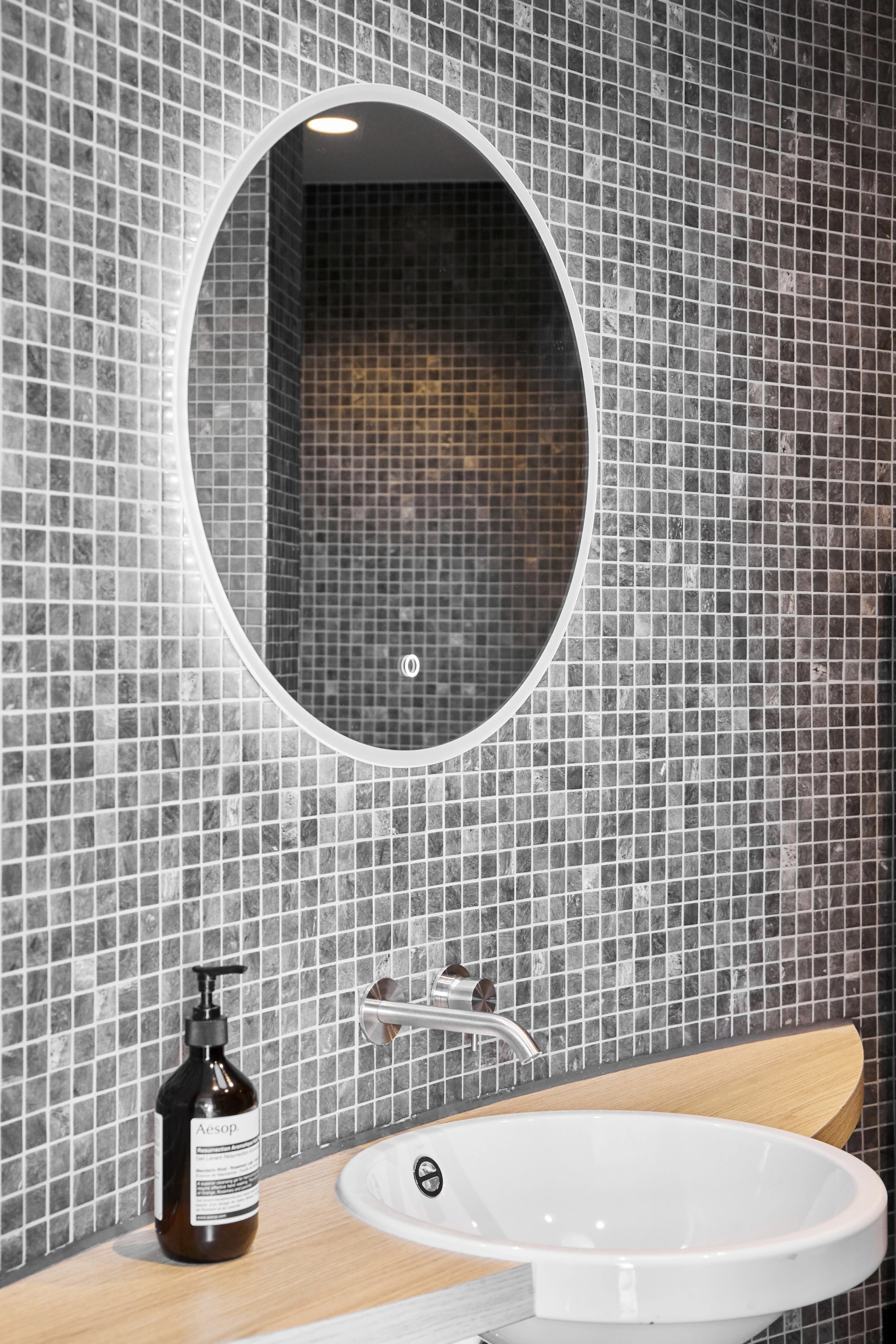 The LumiPod's bathroom includes a sink and mirror