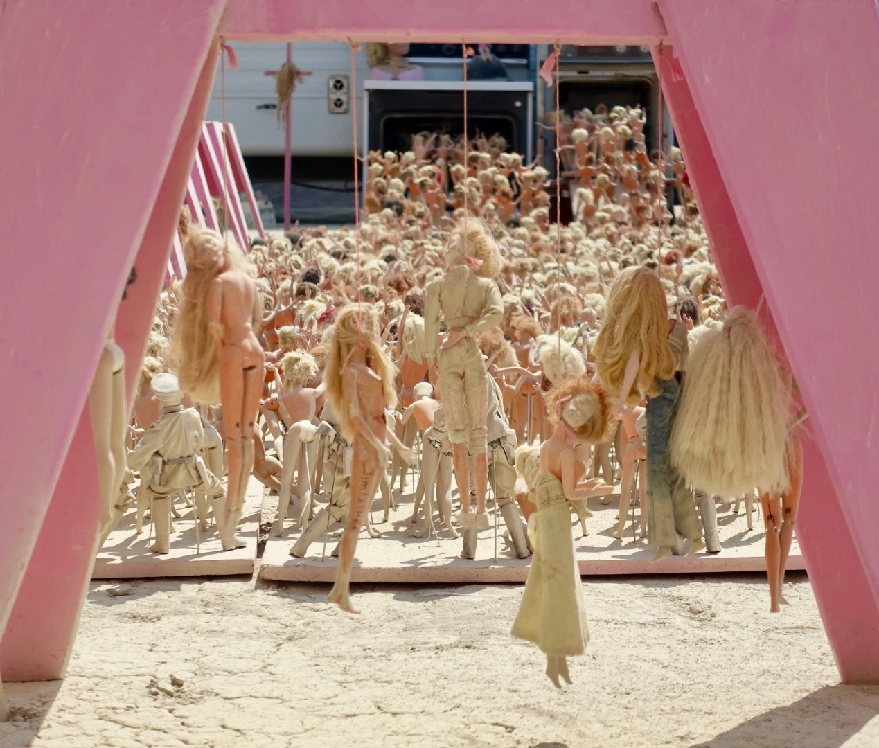 A barbie doll death camp with Ken dolls holding machine guns surveying the perimeter