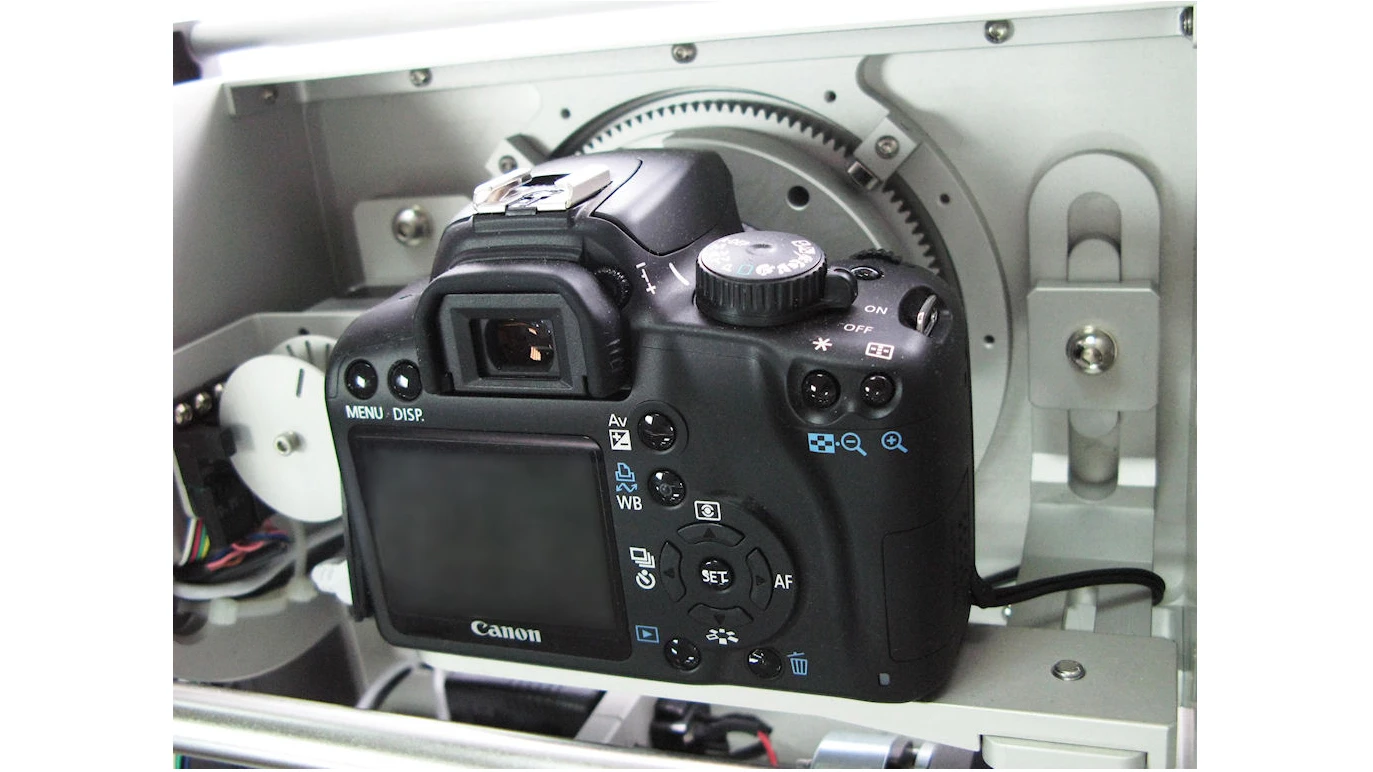A Canon DSLR is mounted to the mechanical track in the Photosimile 5000