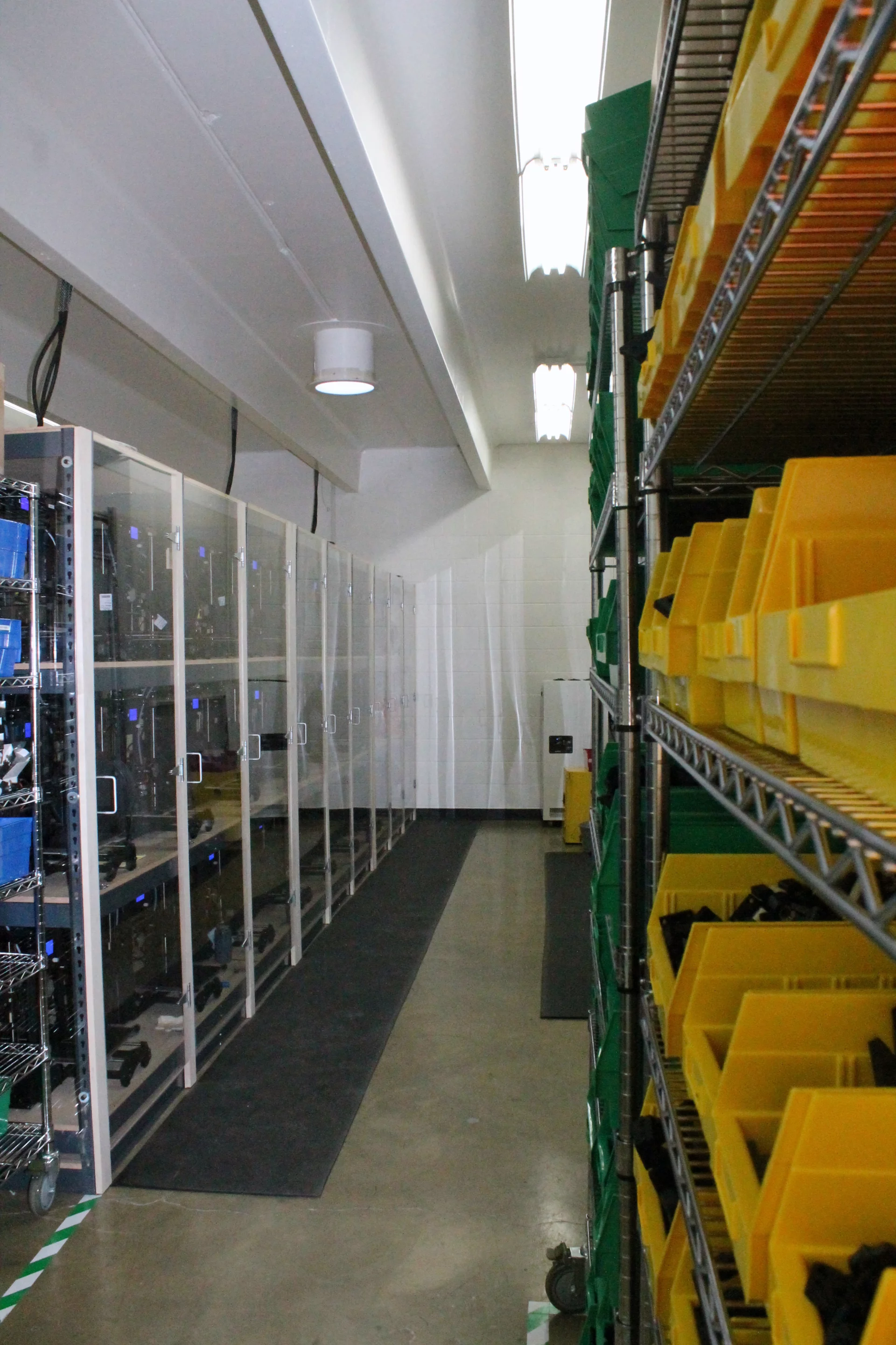 Parts housed in yellow bins wait to be added to future printers, some shipping as early as tomorrow