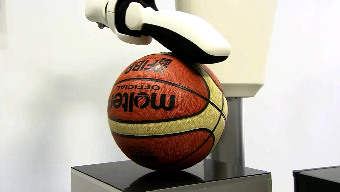 A rigid robot arm would push this ball right off the table, but Toyota's arm simply comes to rest